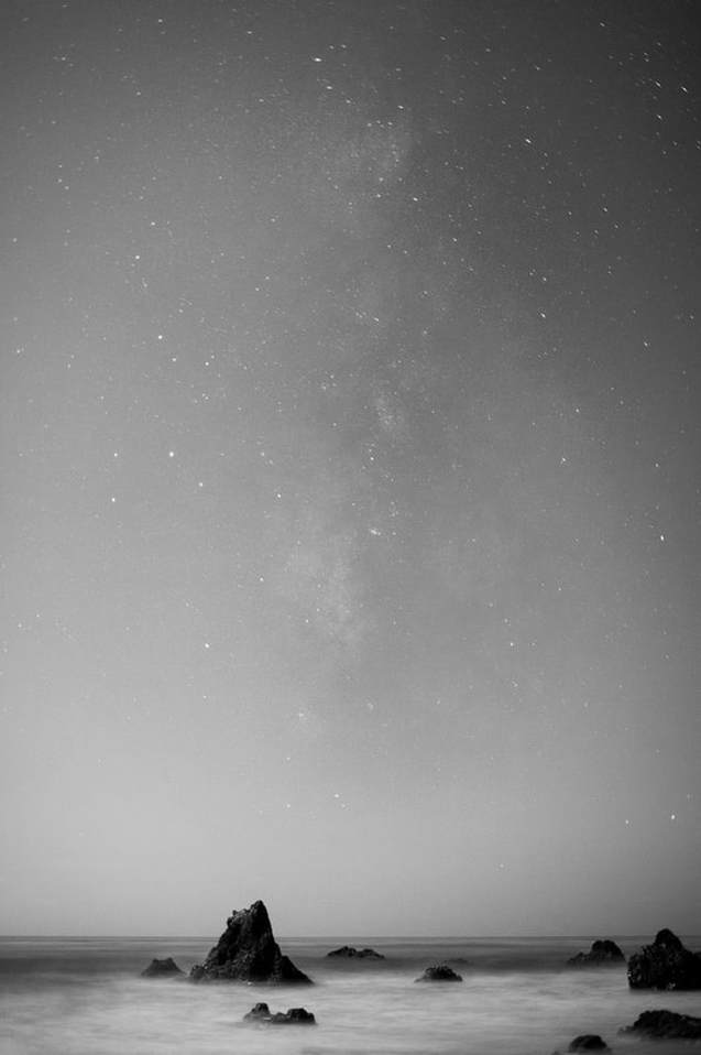 Milky Way over sea stacks on the California coast, in black and white